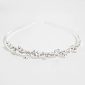 Close-up of elegant silver headband featuring sparkling rhinestones and oval crystals