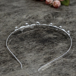 Macro shot of silver metal headband featuring intricate rhinestone leaf decorations