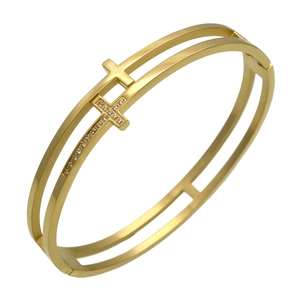 Detailed view of golden double-layer stainless steel bangle with diamond-set cross charms