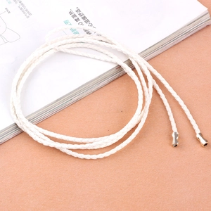 White braided thin belt with golden metal pendants for dresses shown from a top view