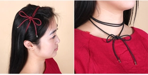 Detail of woven rope belt used as a red headband and a black double-layered choker necklace