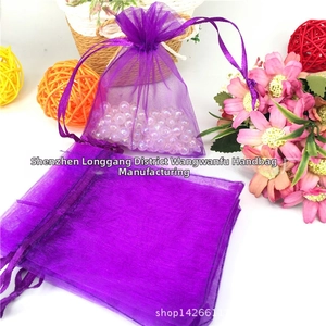 Close-up of purple organza drawstring pouches used for jewelry and gift packaging