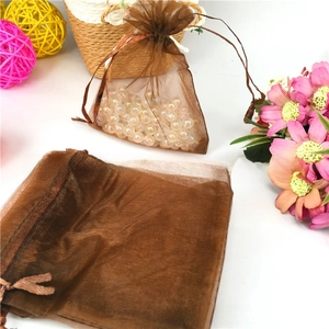 Brown drawstring organza gift bag with semi-transparent mesh texture and beads