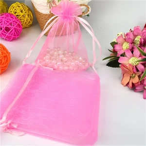 Close-up of pink organza drawstring gift bag with semi-transparent mesh and satin ribbon