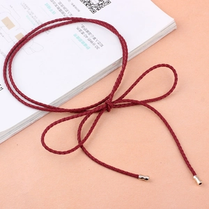 Braided red women's waist belt with golden metal ends tied in a minimalist bow style