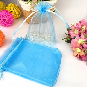 Sky blue organza drawstring bag with silver snowflake print and decorative pearls