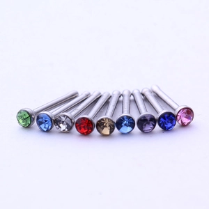 Set of 9 colorful 1.8mm stainless steel nose studs with crystal zircons on white backdrop