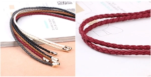 Detail of multi-color woven waist belts with metallic gold tips for women dresses