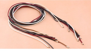 Braided leather waist belts in black, white, and brown with metallic aglet tips