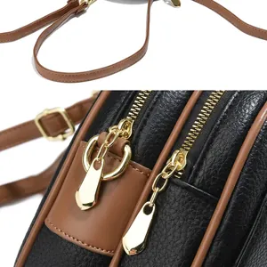 Detailopname van de vintage lederen textuur en de gouden ritssluiting van de tas