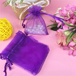 Purple organza drawstring bags for jewelry packaging with translucent mesh texture
