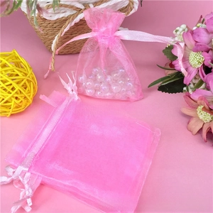 Detailed view of pink organza drawstring bags for jewelry packaging with ribbon closure