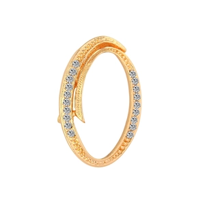 Detailed view of an oval gold-plated brooch with sparkling rhinestones on one side