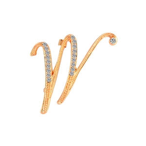Close-up detail of golden letter W brooch featuring sparkling round crystal rhinestones