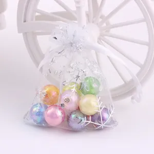 White organza Christmas gift bag with silver snowflakes and colorful pearl beads