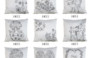 Macro view of assorted black and white DIY doodle pillowcases with floral and figure patterns