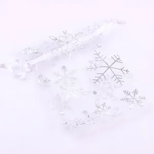 White organza Christmas gift bags with silver snowflake print and drawstring closure