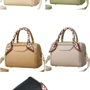 Detail view of lychee grain leather handbag in multiple colors with silk scarf handle