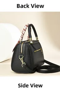 Detail of black pebbled leather handbag with geometric silk scarf and back zipper pocket