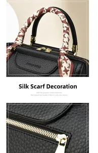 Close-up of black lychee grain leather handbag with silk scarf wrapped on the handle