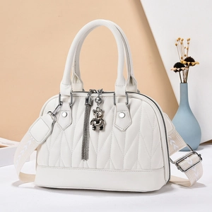 Chic beige pleated handbag with quilted pattern and decorative bear pendant