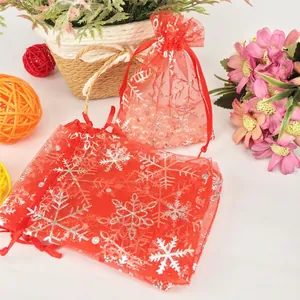 Red organza Christmas gift bag with silver snowflake print and drawstring closure