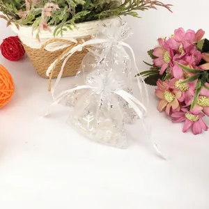 White organza Christmas gift bag with silver snowflake print and ribbon drawstring closure