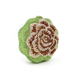 Detail of rose-shaped evening clutch with sparkling rhinestones and hollow metalwork