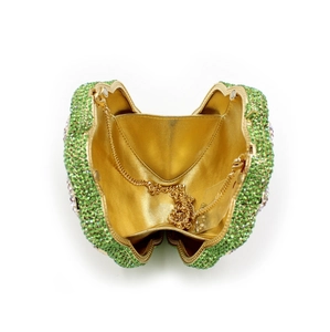 Macro view showing the open green rhinestone heart evening bag with golden metal lining