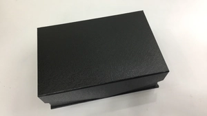 Nahaufnahme einer schwarzen Geschenkbox mit einer edlen geprägten Ledertextur für Taschen
