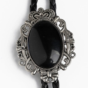Detail of vintage crown bolo tie featuring black agate stone in an ornate silver frame