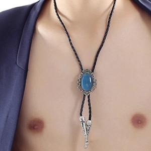 Detail of blue turquoise silver crown bolo tie pendant on a black braided leather cord