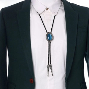 Detail of vintage Western bolo tie with blue cat's eye stone and crown silver frame