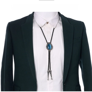 Close-up of vintage bolo tie with blue stone and silver crown on suit outfit