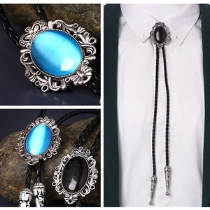 Detail of turquoise and onyx bolo ties with vintage silver base and braided leather cord