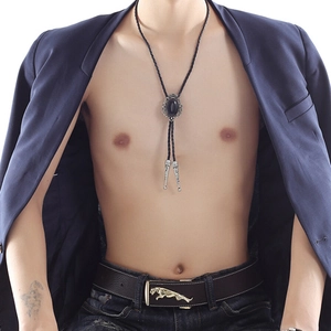 Detail of crown agate bolo tie with black gemstone and silver tips on male model