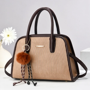 Elegant light brown striped handbag with gold hardware and luxury plush charm