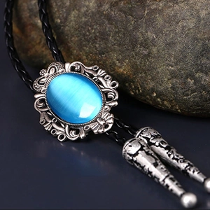 Detail of silver crown bolo tie with blue oval stone on black braided leather cord