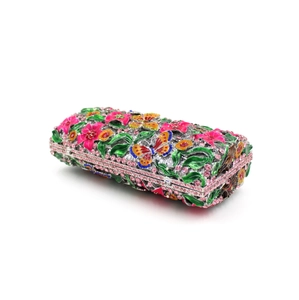 Detailed view of the colorful crystal encrusted floral pattern on a luxury clutch bag