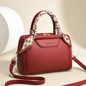 Chic burgundy leather Boston bag with houndstooth scarf handle and adjustable strap