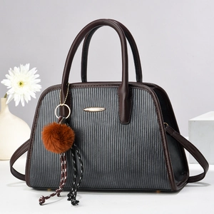 Gray textured crossbody handbag with brown handles and a gold metal accent decoration