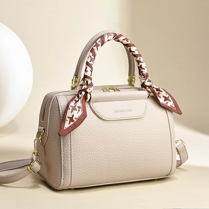 Chic beige lychee leather Boston bag with houndstooth silk scarf handle and gold hardware