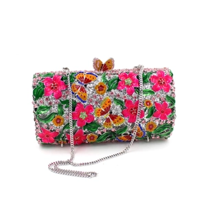Detail of evening clutch featuring pink and yellow enamel flowers with crystal butterflies