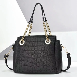 Minimalist black crocodile pattern handbag with gold chain handle and leather strap