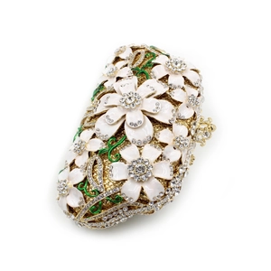 Macro detail of crystal floral evening bag with rhinestones and green enamel leaves