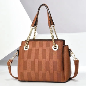 Vintage brown textured leather handbag with gold chain handle and woven detail