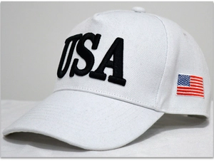 Detail of USA embroidery and American flag patch on white cotton baseball cap