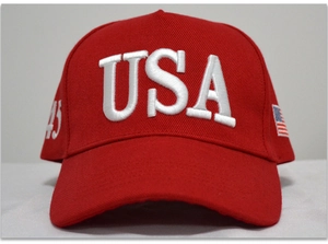Close-up of red cotton baseball cap featuring white 3D USA embroidery and side flag detail
