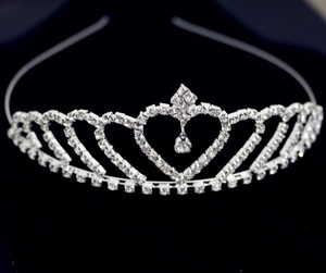 Macro shot of silver princess tiara with heart pattern and sparkling rhinestones