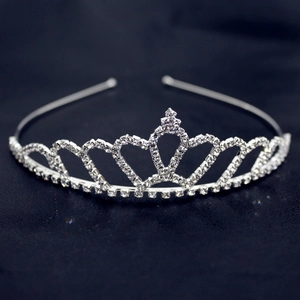 Detail shot of silver tiara headband featuring hollow heart patterns and shiny rhinestones